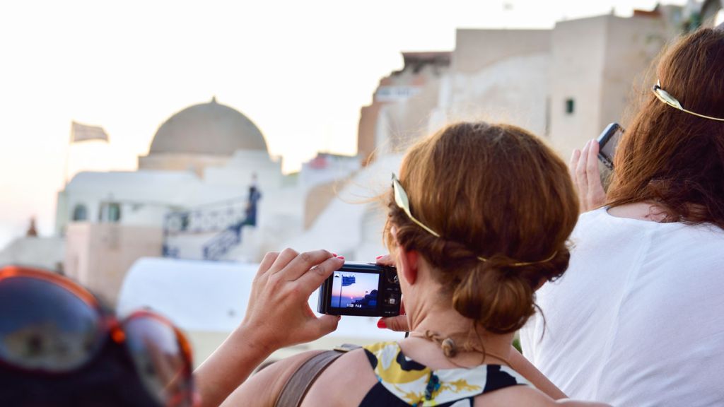 Frau macht Fotos in Oia Santorini Frau macht Fotos in Oia Santorini